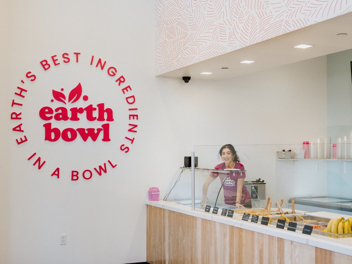 Earth Bowl interior with brand wall and light wood topping bar counter