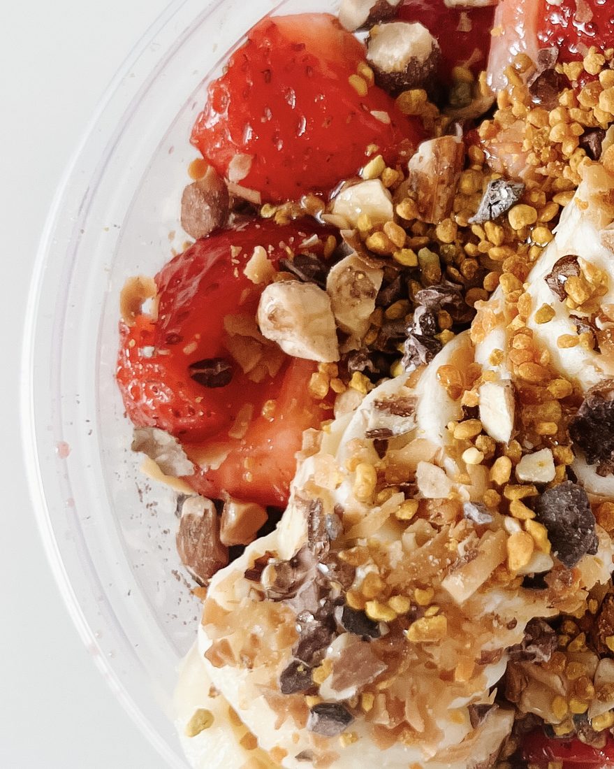 Close-up of strawberries, coconut and crunchy toppings